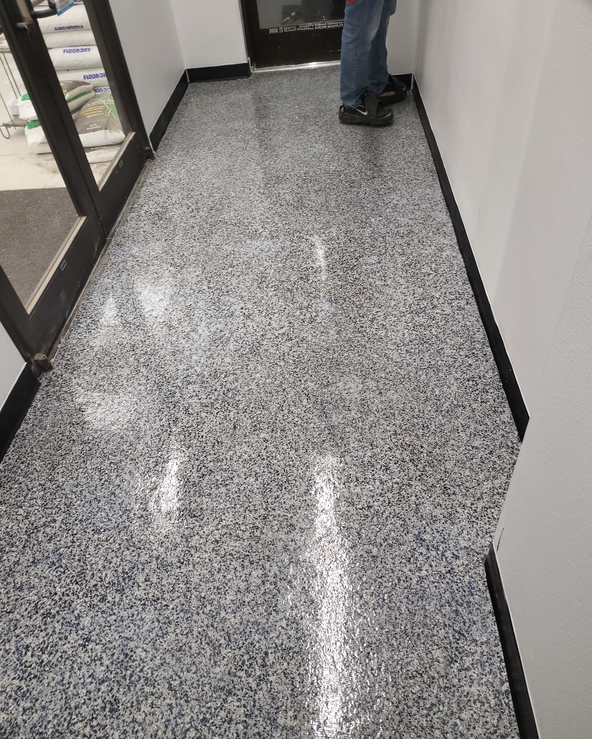 Finished commercial epoxy flake floor with a high gloss finish in an entryway